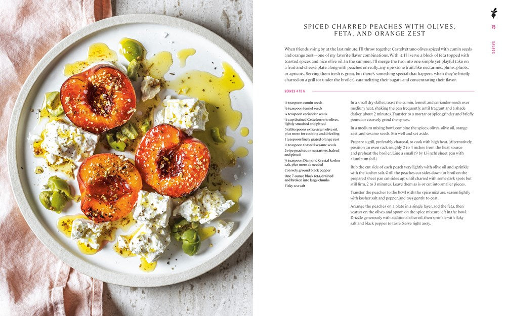 A plate of charred peaches, feta, olives, and orange zest—drizzled with olive oil and seasoning—sits beside Cook Like a King by Melissa King (with Signed Bookplate!) from Yu & Me Books.