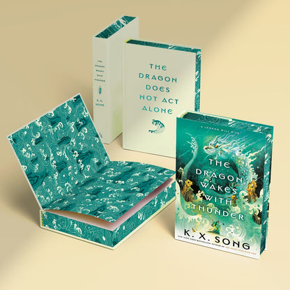 A signed and personalized first edition of Dragon Wakes with Thunder by KX Song, offered by Yu & Me Books, featuring a striking dragon-themed cover.