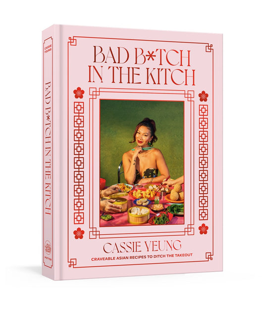 Bad B*tch in the Kitch by Cassie Yeung (Signed & Personalized) from Yu & Me Books features a pink cover with an Asian woman surrounded by dishes and the subtitle "Craveable Asian Takeout Recipes to Ditch the Takeout.