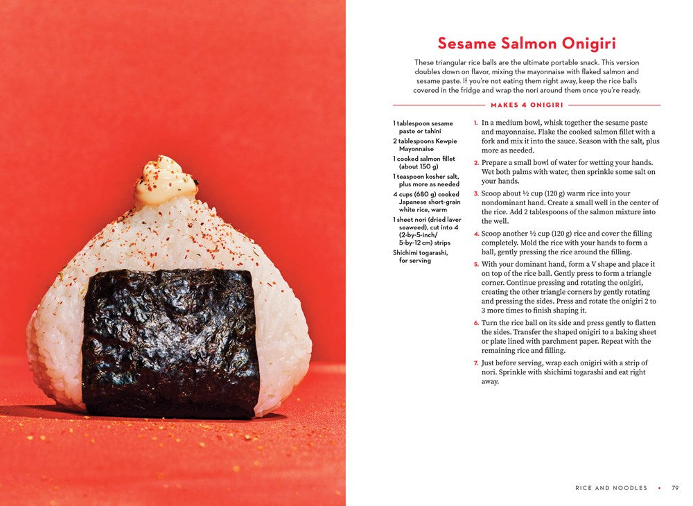 A triangular rice ball (onigiri) with savory filling sits on a white surface. To the right is a Sesame Salmon Onigiri recipe from For the Love of Kewpie by Elyse Inamine & Jessie YuChen (Signed & Personalized), from Yu & Me Books.