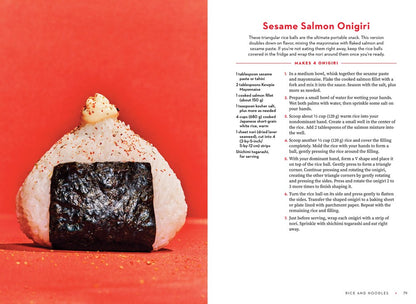 A triangular rice ball (onigiri) with savory filling sits on a white surface. To the right is a Sesame Salmon Onigiri recipe from For the Love of Kewpie by Elyse Inamine & Jessie YuChen (Signed & Personalized), from Yu & Me Books.